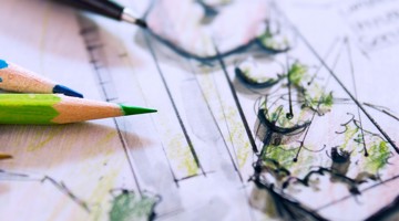 Tekeningen en schetsen van een tuinontwerp, zichtbaar vooraan met groene en blauwe kleurpotloden.